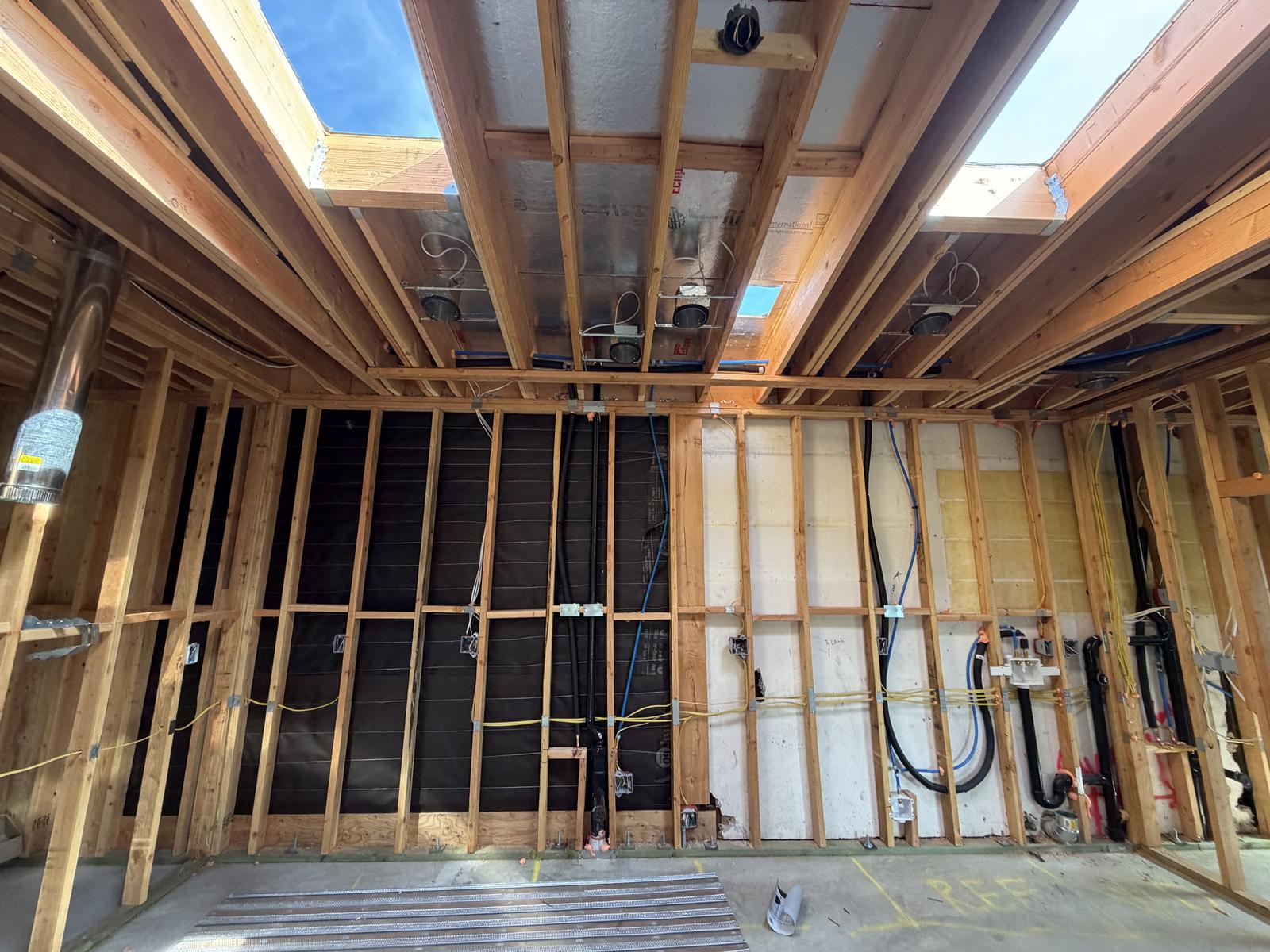 ADU interior framing with ceiling insulation, electrical rough-in, and skylights