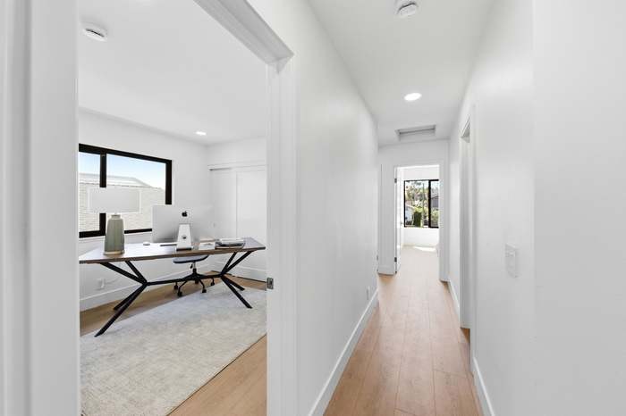 Bedroom remodeled into a home office, viewed from the hallway