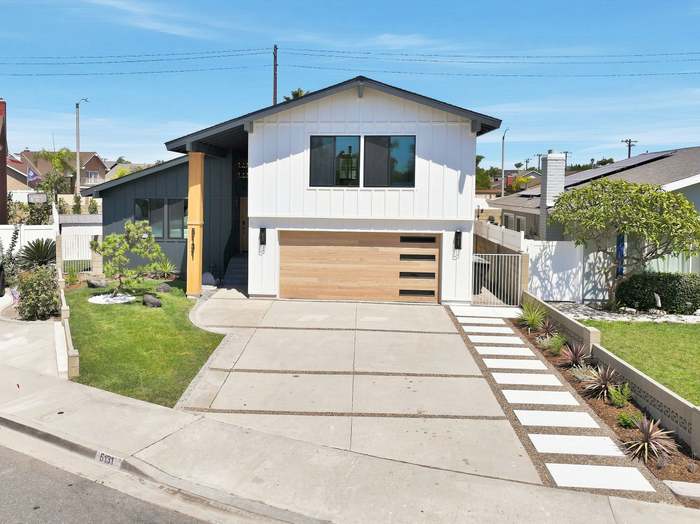 Front yard with new sod lawn, drought-tolerant planting beds, and a paver walkway to the entry